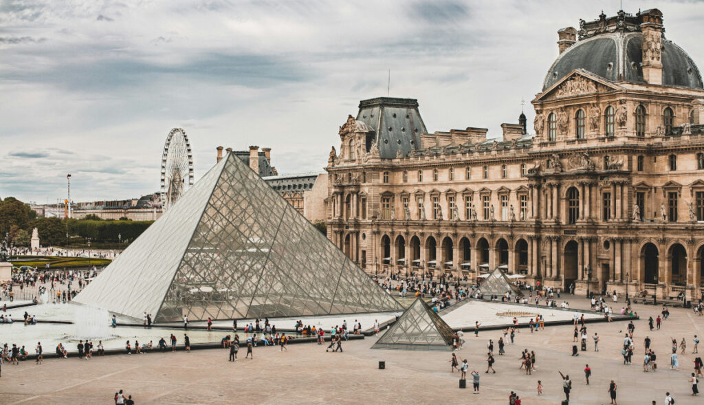 View of the main courtyard of the Louvre Museum in Paris, featuring the glass pyramids