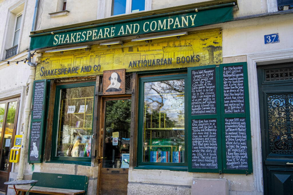 Facade of Shakespeare and Company bookstore with signboard in Paris